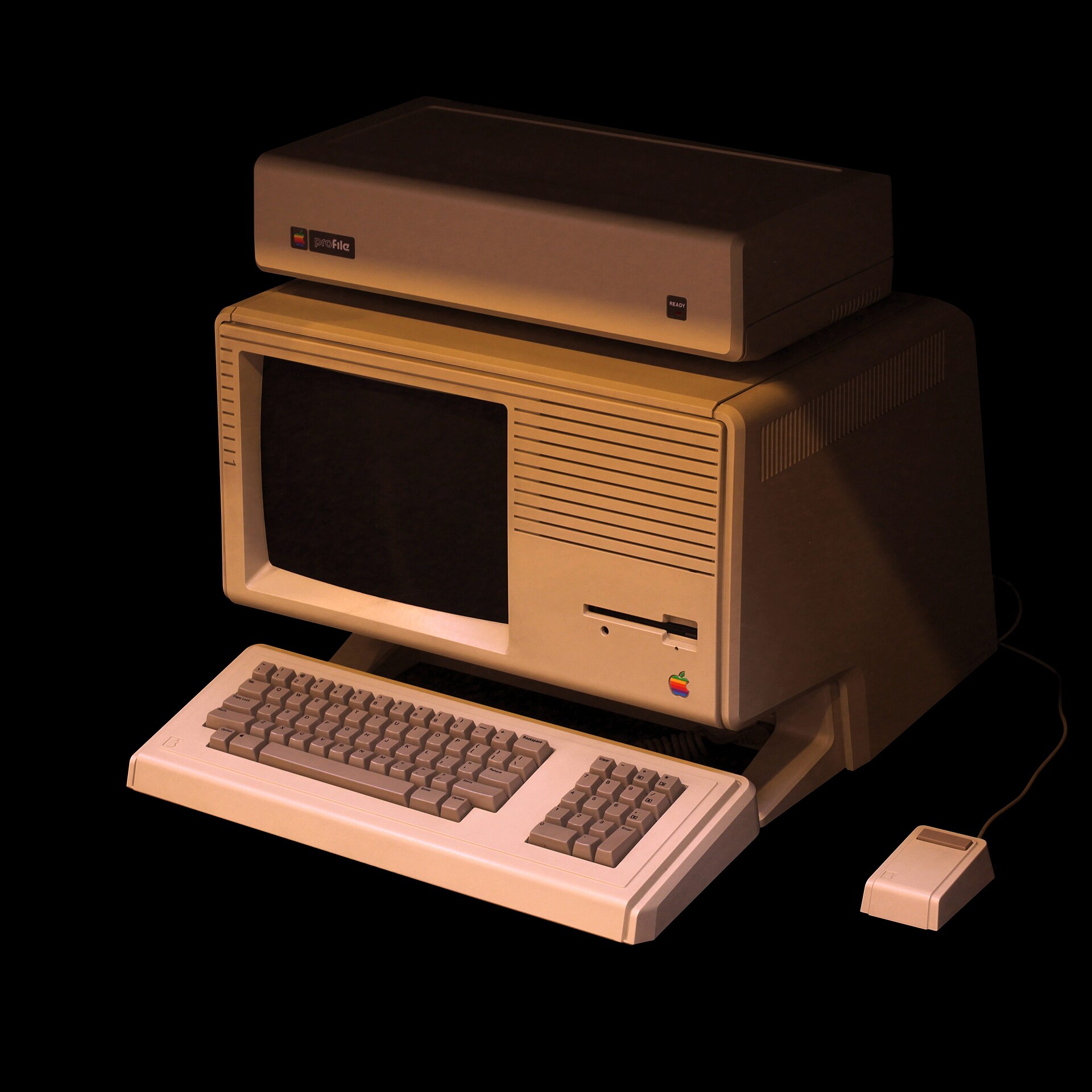 An Apple Lisa computer photographed against a plain background: a beige all-in-one with a built-in monochrome screen, twin floppy slots, and a separate keyboard and mouse.